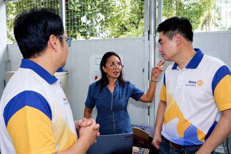 President Reginald Yu listens as a teacher goes through her list of much-needed improvements, while Director Nico Valencia looks on.