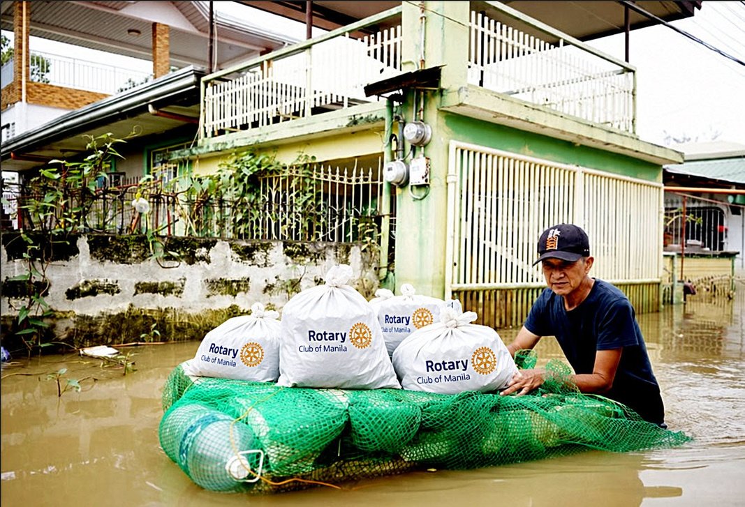 A resident of Barangay Bulusan tows his relief goods home on a raft of used plastic containers.